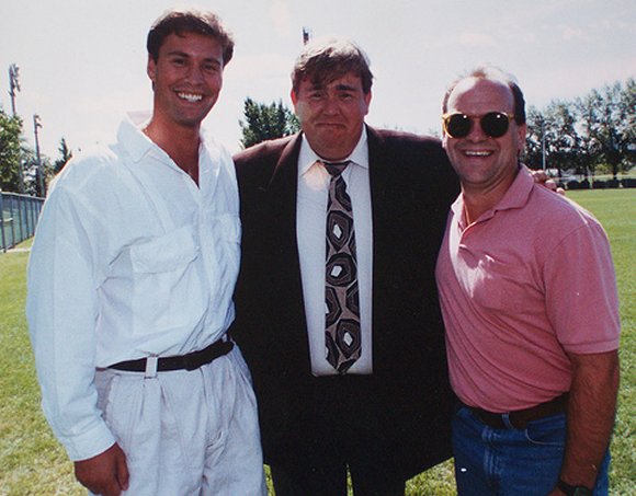 John Candy with some guys at the Toronto Argonauts training ground.